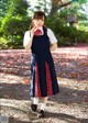 A woman in a school uniform is posing for a picture.