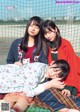 A group of young women sitting next to each other on a blanket.